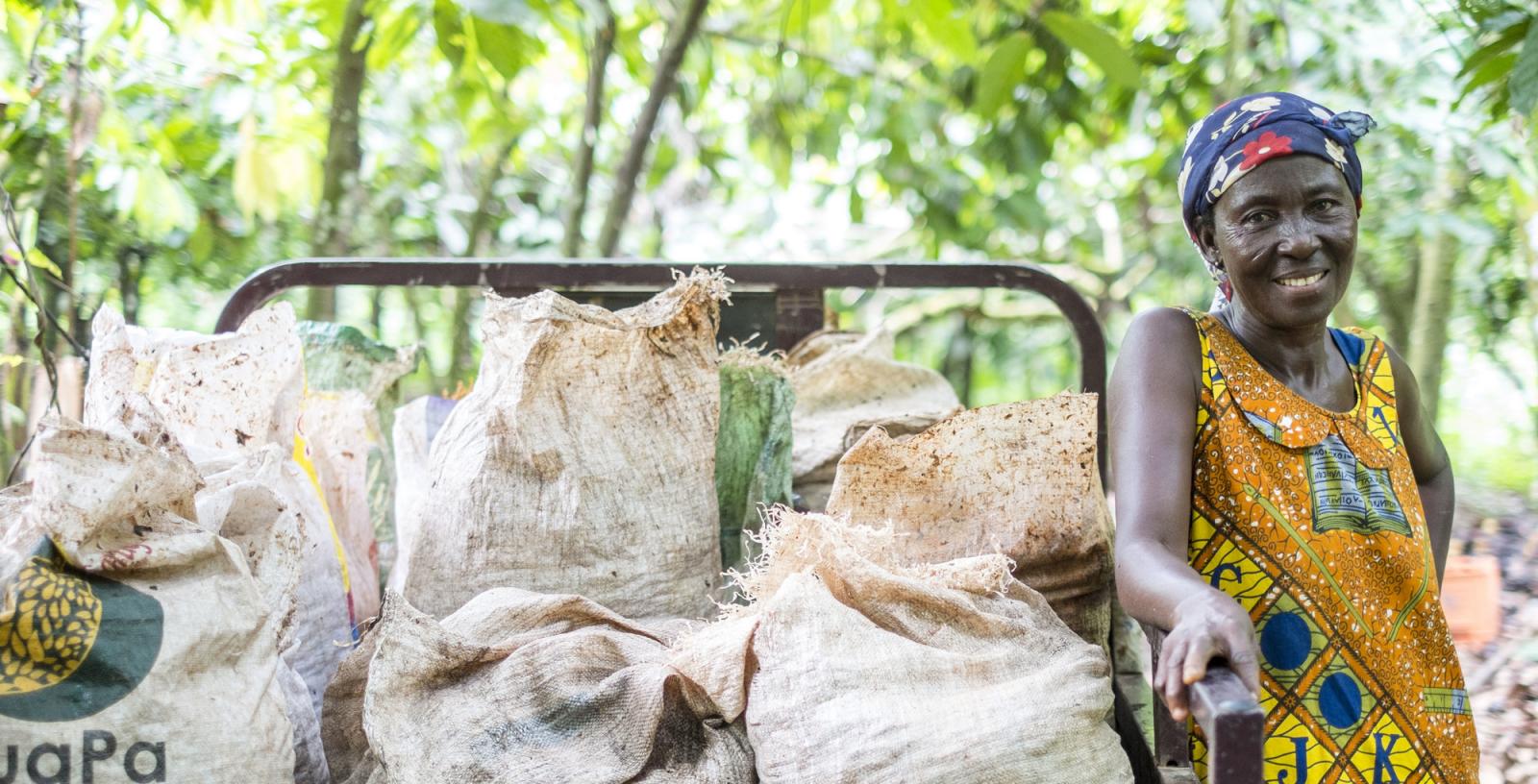 A farmer standing next to their harvested crops