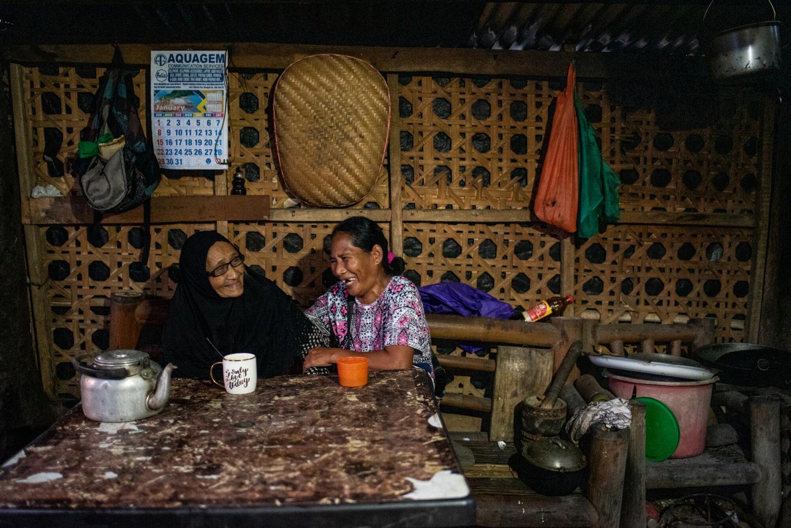 Two friends share a pot of tea