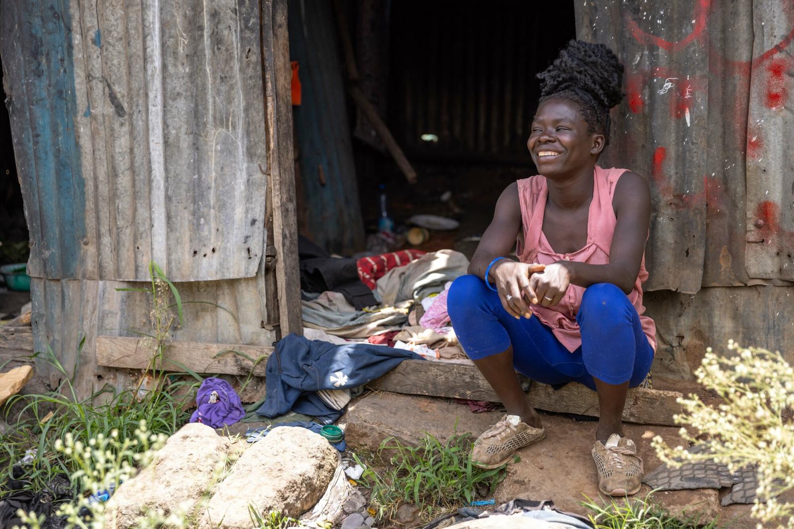 Waste picker outside her house