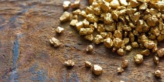 Mound of gold on an old table.