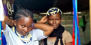 Young women making bead jewellery 