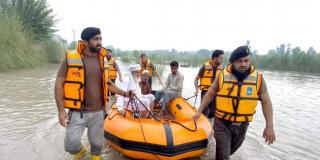 Community emergency response team pull a boat from the water