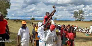 Football team lifting trophy