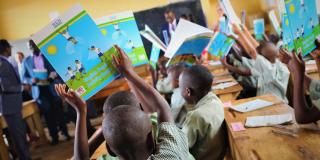 children holding text books