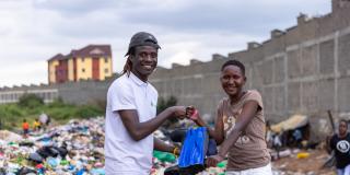 VSO volunteer Lawrence distributing PPE to waste picker Vanessa.