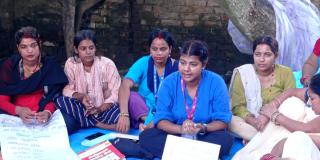 Aarati talking to local women