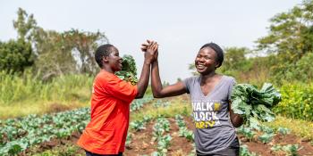 Female farmers high-fiving