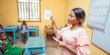 Volunteer trained by Uzoamaka Onyinye Didigwu teaching in the classroom.