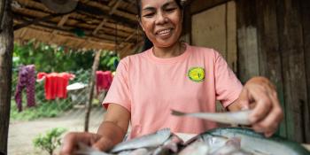 Woman cutting fish