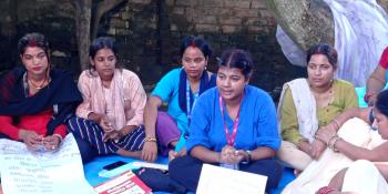 Aarati talking to local women