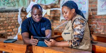 Two people using tablet