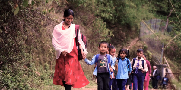 Nirmala leading the children to class