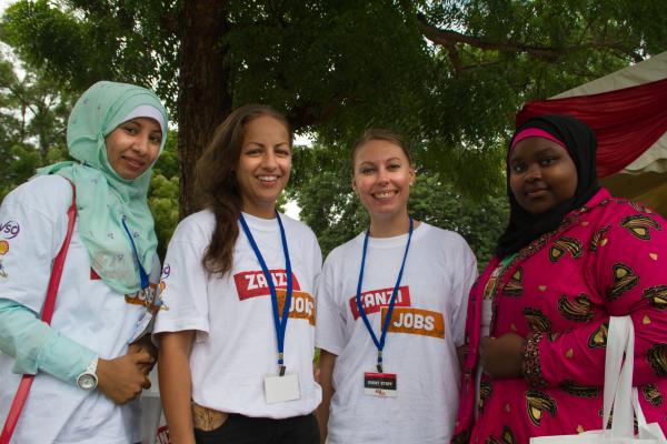 Dutch Randstad volunteers Daisy Spangenberg and Kim Van Nijnatten with Rakhil Saleh Kombo, a gender and youth worker, and Wahdat Suleiman Ali, an accountant, at the Zanzi Jobs fair.