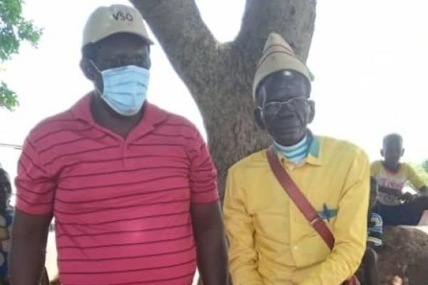 Daniel Adotu pictured with older man in Rhino Camp, Uganda.