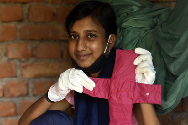 Big Sister holding a home made sanitary pad