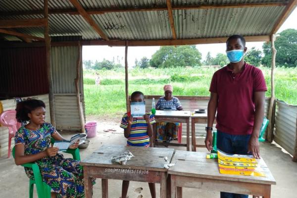 National Volunteer in Mtwara, Tanzania distributing flyers to raise awareness about COVID19. 