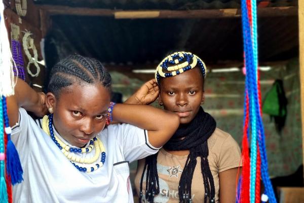 Young women making bead jewellery 