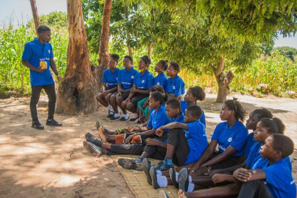 Zambian community volunteer delivering a lesson using a Talking Book