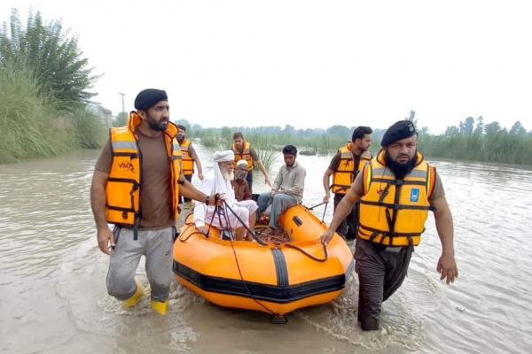 Community emergency response team pull a boat from the water