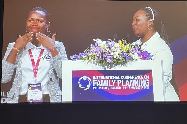 Rwandan volunteer Brown accepting award for Excellence in Leadership for Family Planning