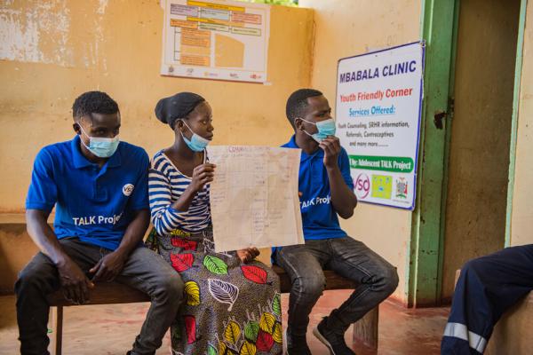 Community volunteers meet with clinic staff to present their reports from their community activities