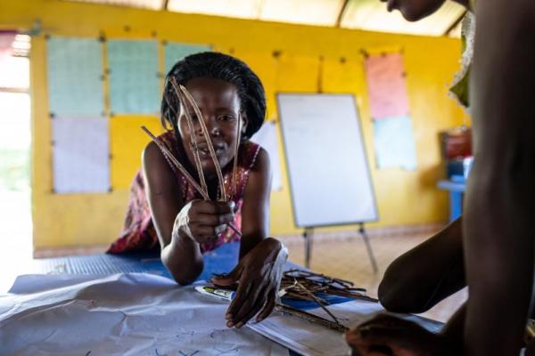 Christine teaching maths using sticks