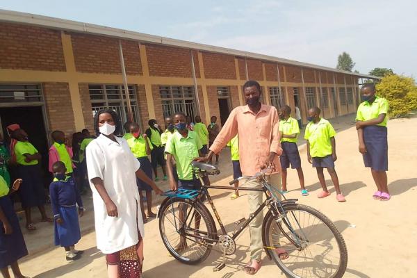 Bicycle gifted to help Uwimpuhwe go to school.