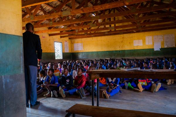 Teacher Peter standing in front of his class of 200 students