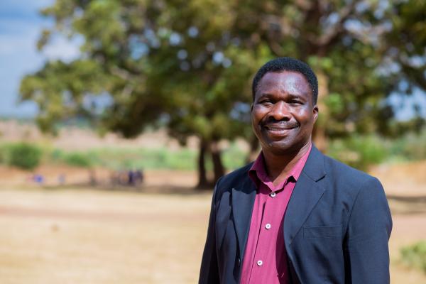 Theonas stands in one of the many schools he volunteers at in Malawi