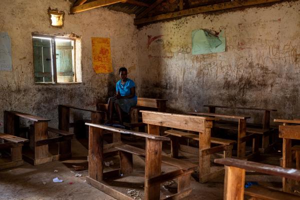 Girl sat in empty classroom