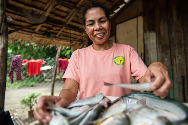 Woman cutting fish