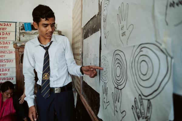 Adolescent boy participating in gender-based violence workshop