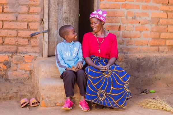 Student Lonjezo with his mother outside their home.