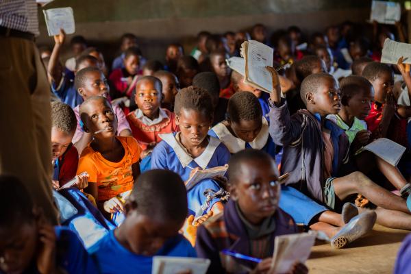 Students learning in a cramped classroom.