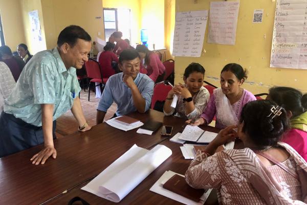 Volunteer chatting to local teachers.