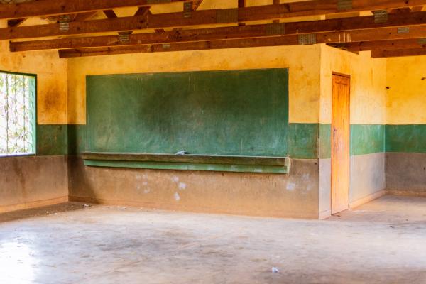 An empty classroom with a blackboard.