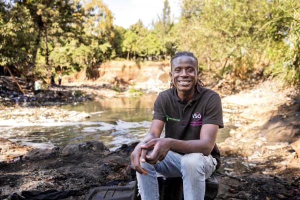 Lawrence, community volunteer by polluted river in Nairobi