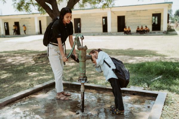 Volunteer using handpump