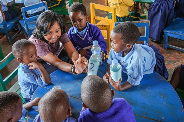 Volunteer helps children during math class