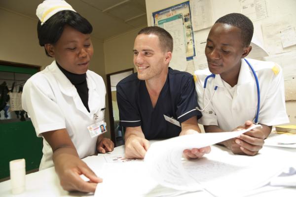 David Atherton with his students Diana Liphana and Stevien Saiwala. David, THET programme VSO volunteer at work in St Lukes Hospital, Zomba district, Malawi